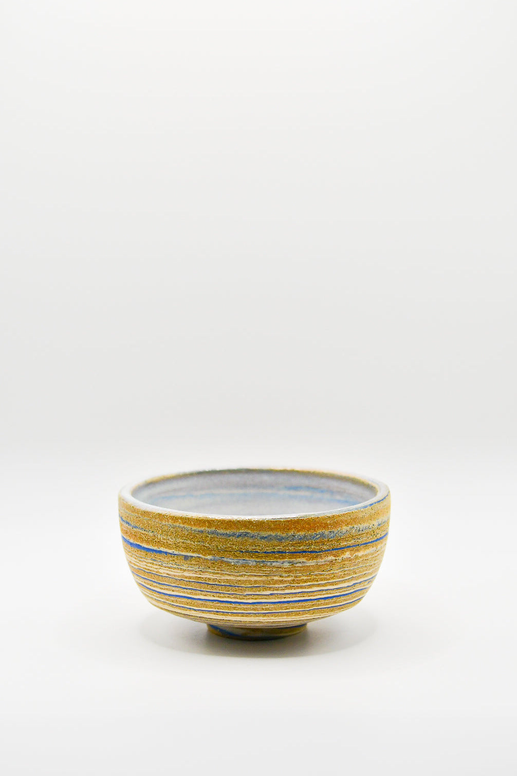 Small ceramic bowl with striped design on a white background