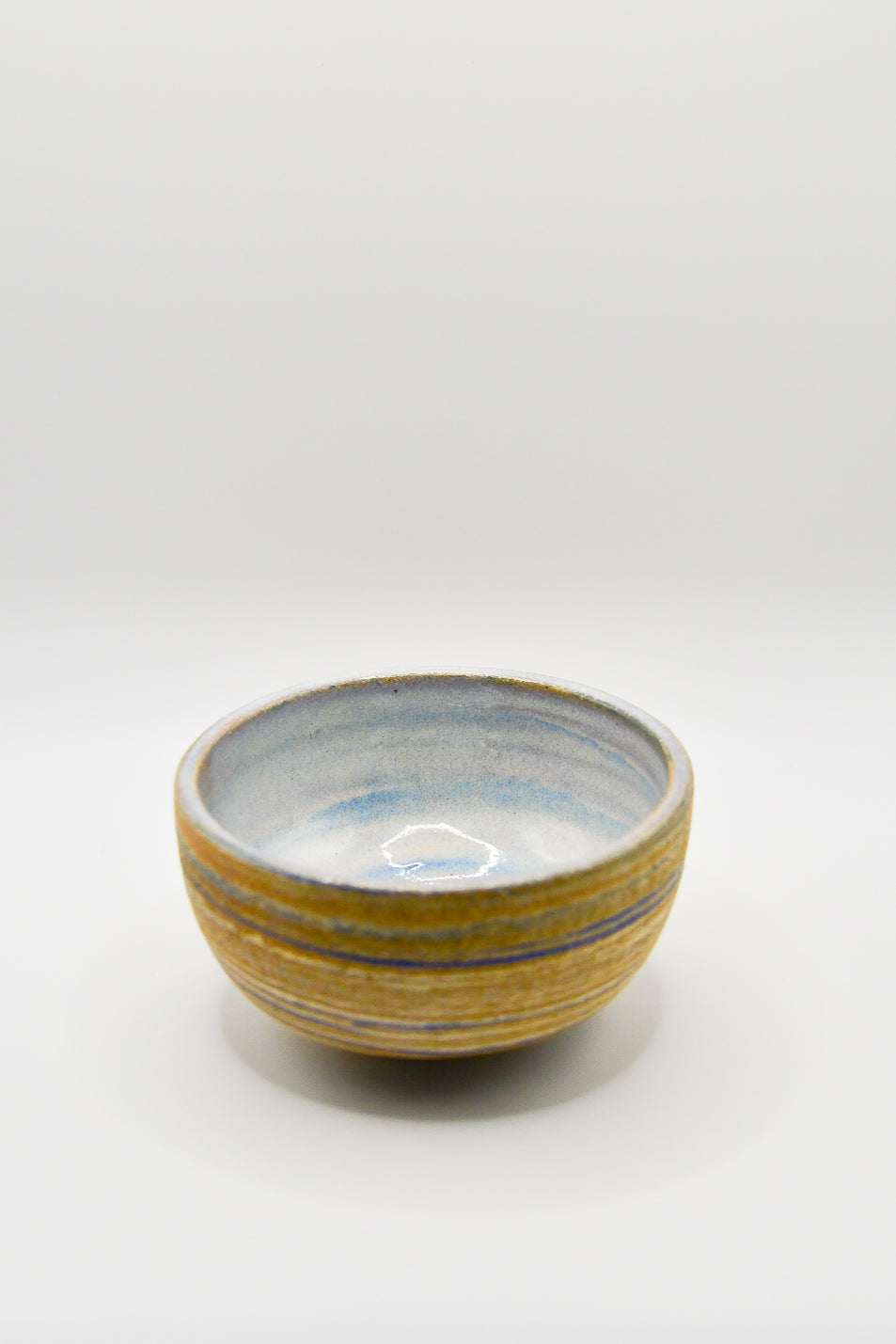 Small ceramic bowl with a striped design on a white background