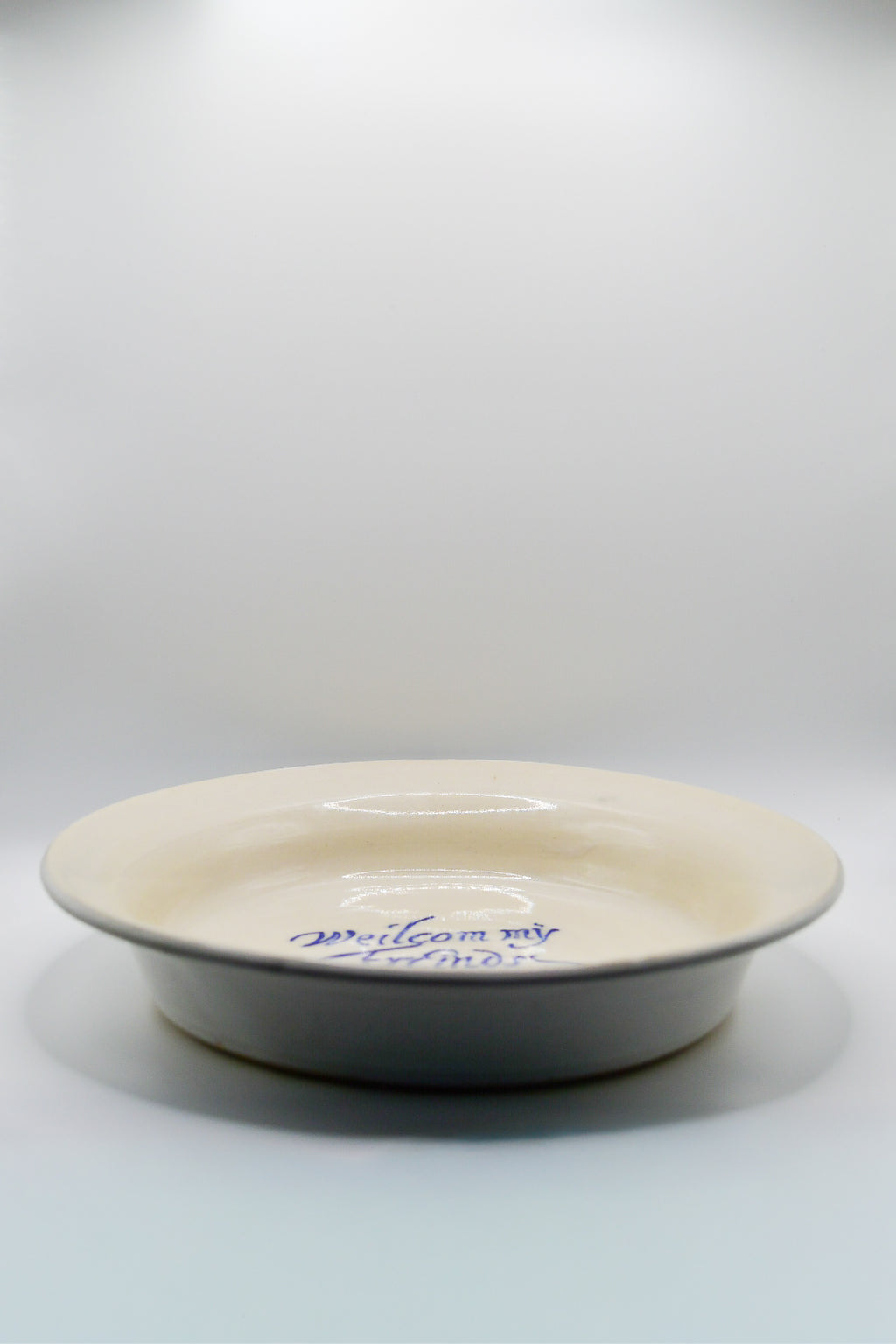 White ceramic plate with blue text on a white background