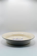 White ceramic plate with blue text on a white background