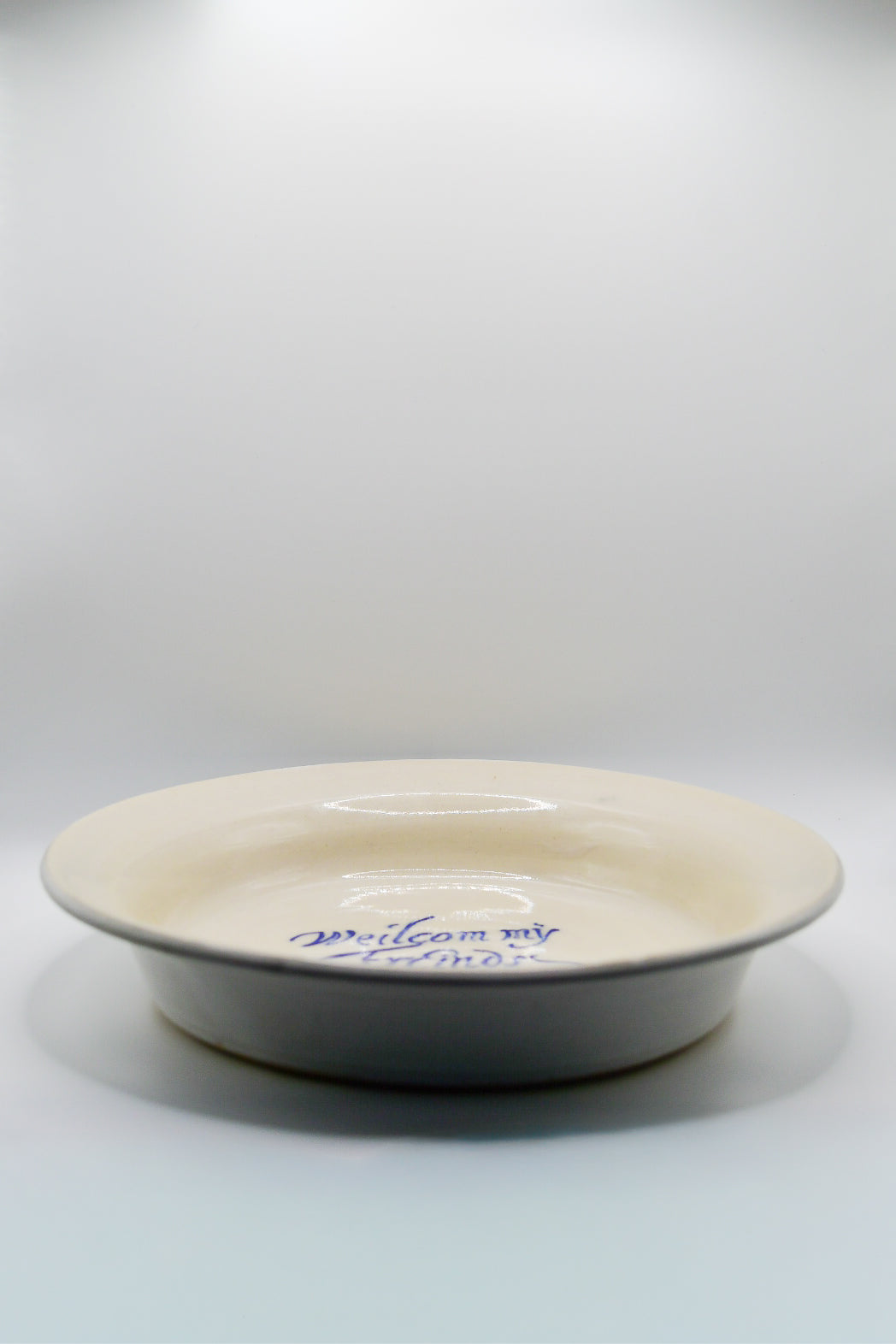 White ceramic plate with blue text on a white background