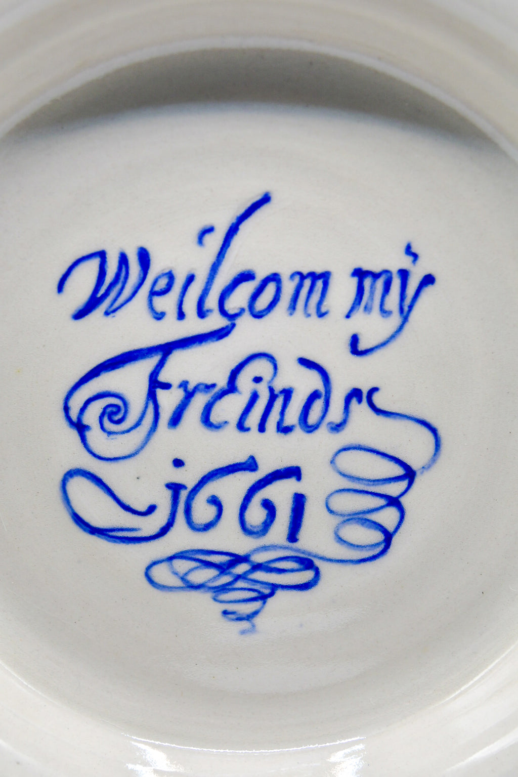 White ceramic plate with blue text on a white background