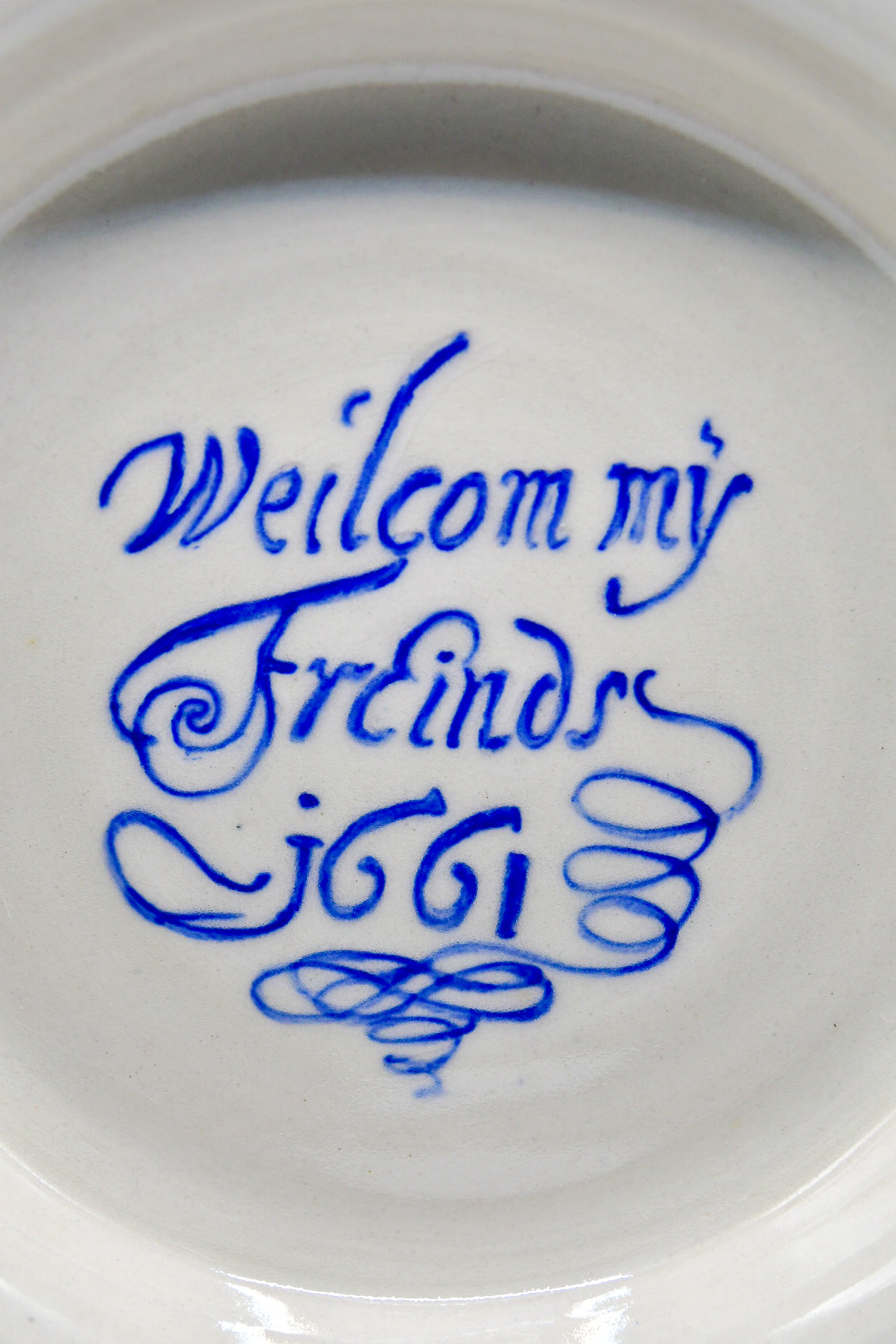 White ceramic plate with blue text on a white background