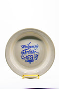 White ceramic plate with blue text on a white background