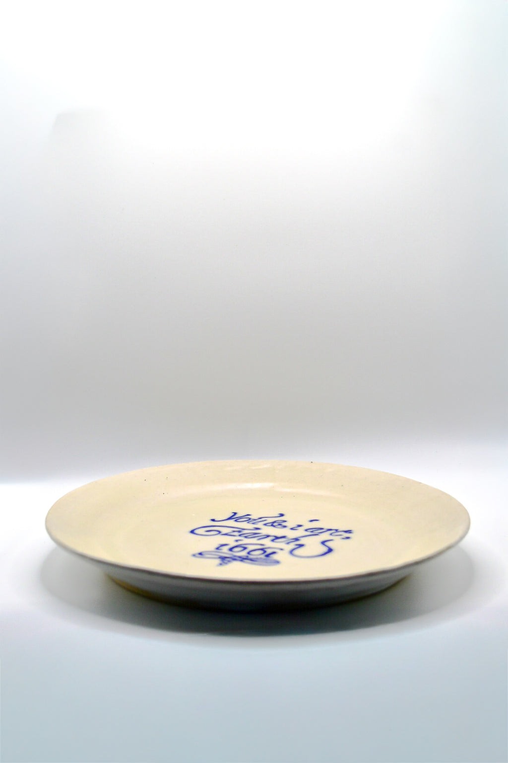 White ceramic plate with blue text on a white background