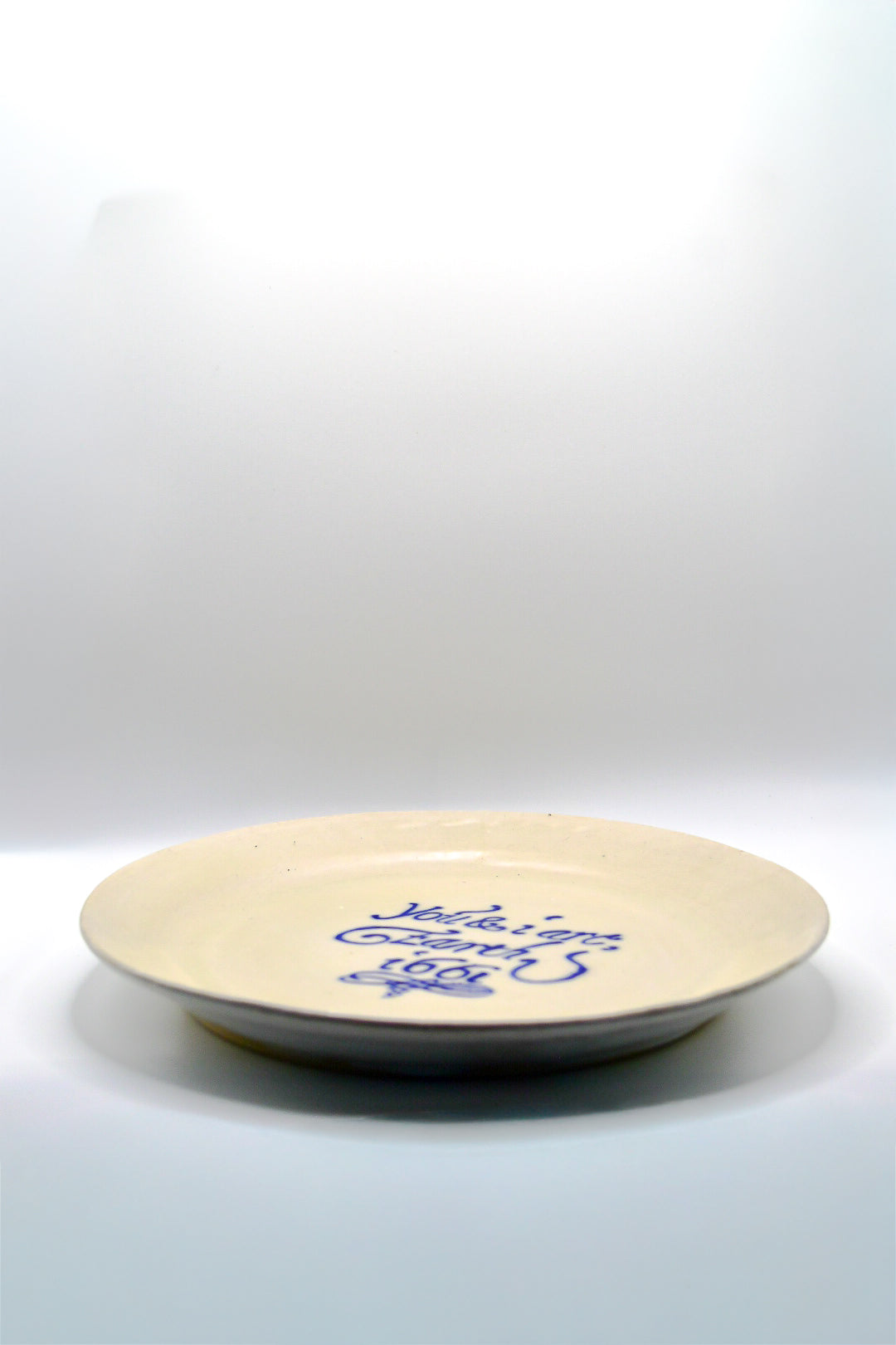 White ceramic plate with blue text on a white background