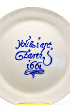 White ceramic plate with blue text on a white background