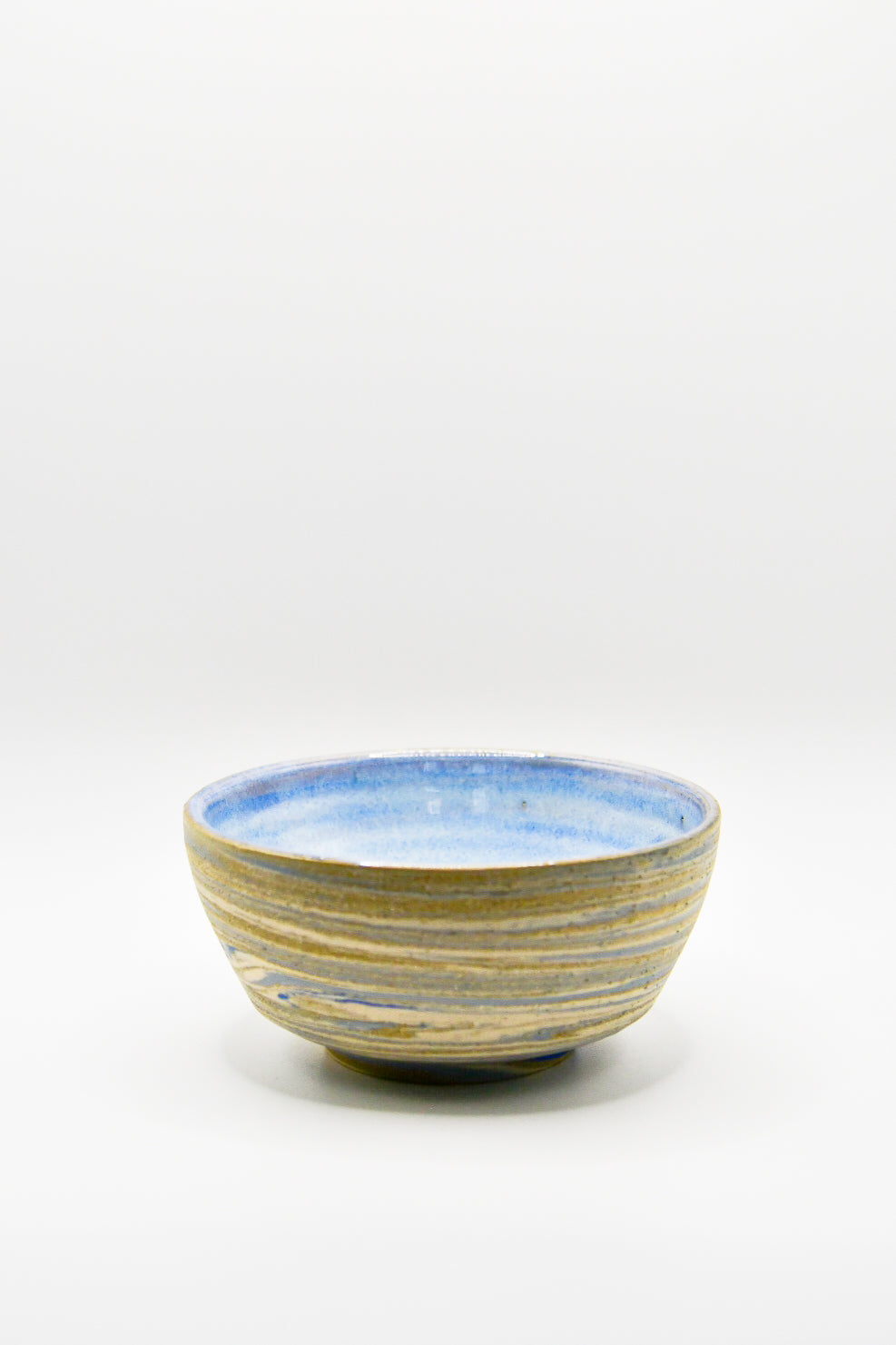 Ceramic bowl with blue and gold stripes on a white background