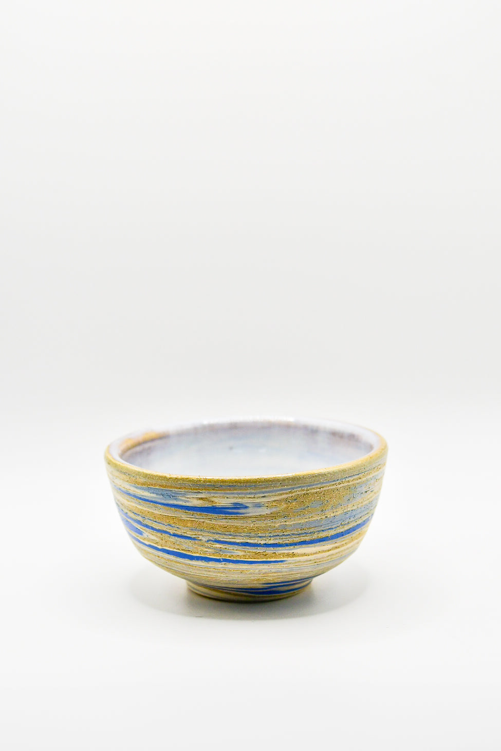 Ceramic bowl with blue and yellow stripes on a white background