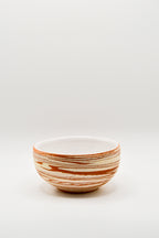 Ceramic bowl with striped pattern on a white background