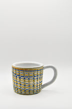 Ceramic mug with blue and beige pattern on a white background