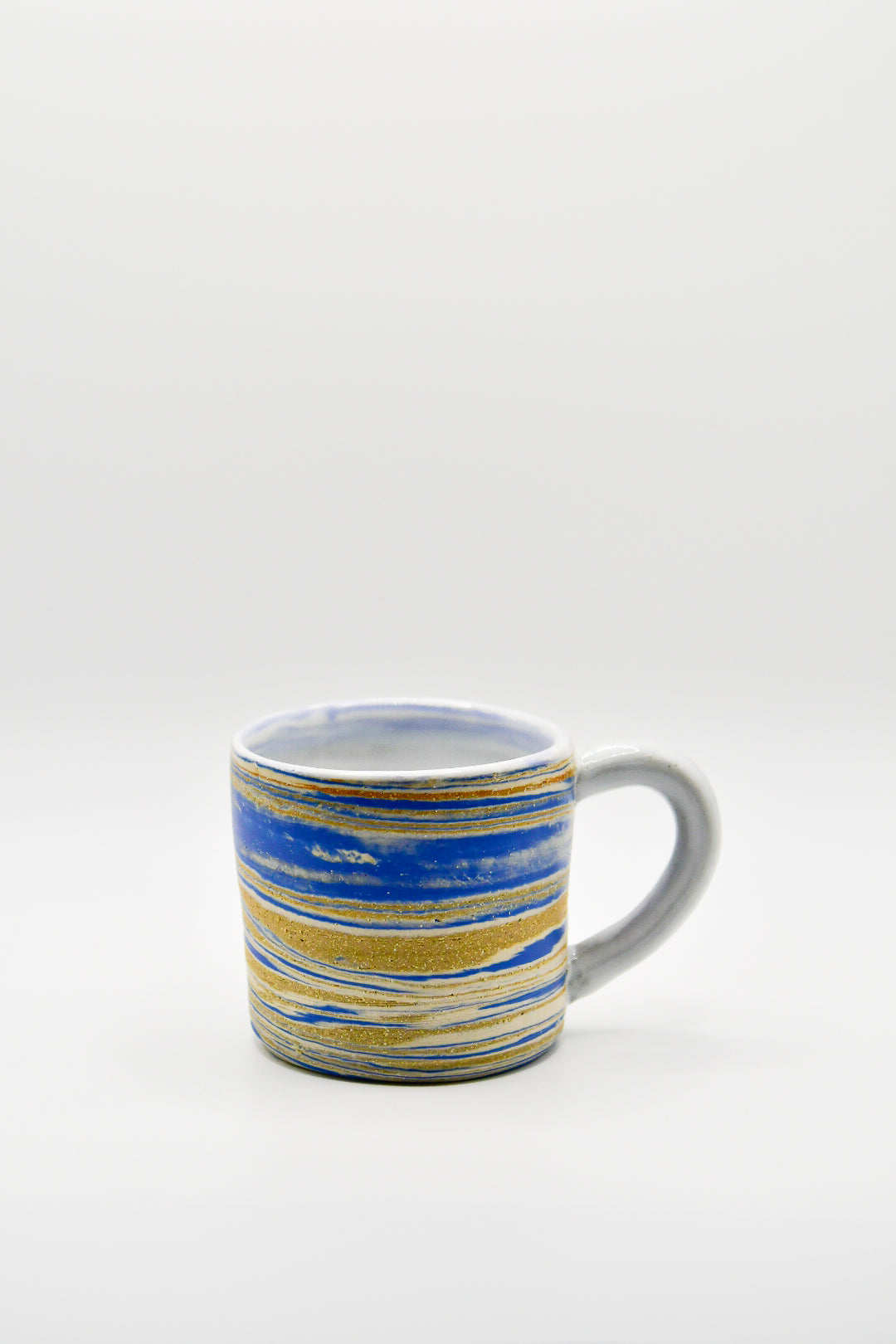 Ceramic mug with blue and gold stripes on a white background