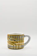 Ceramic mug with blue and beige pattern on a white background