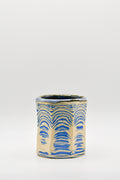 Ceramic cup with blue and beige pattern on a white background
